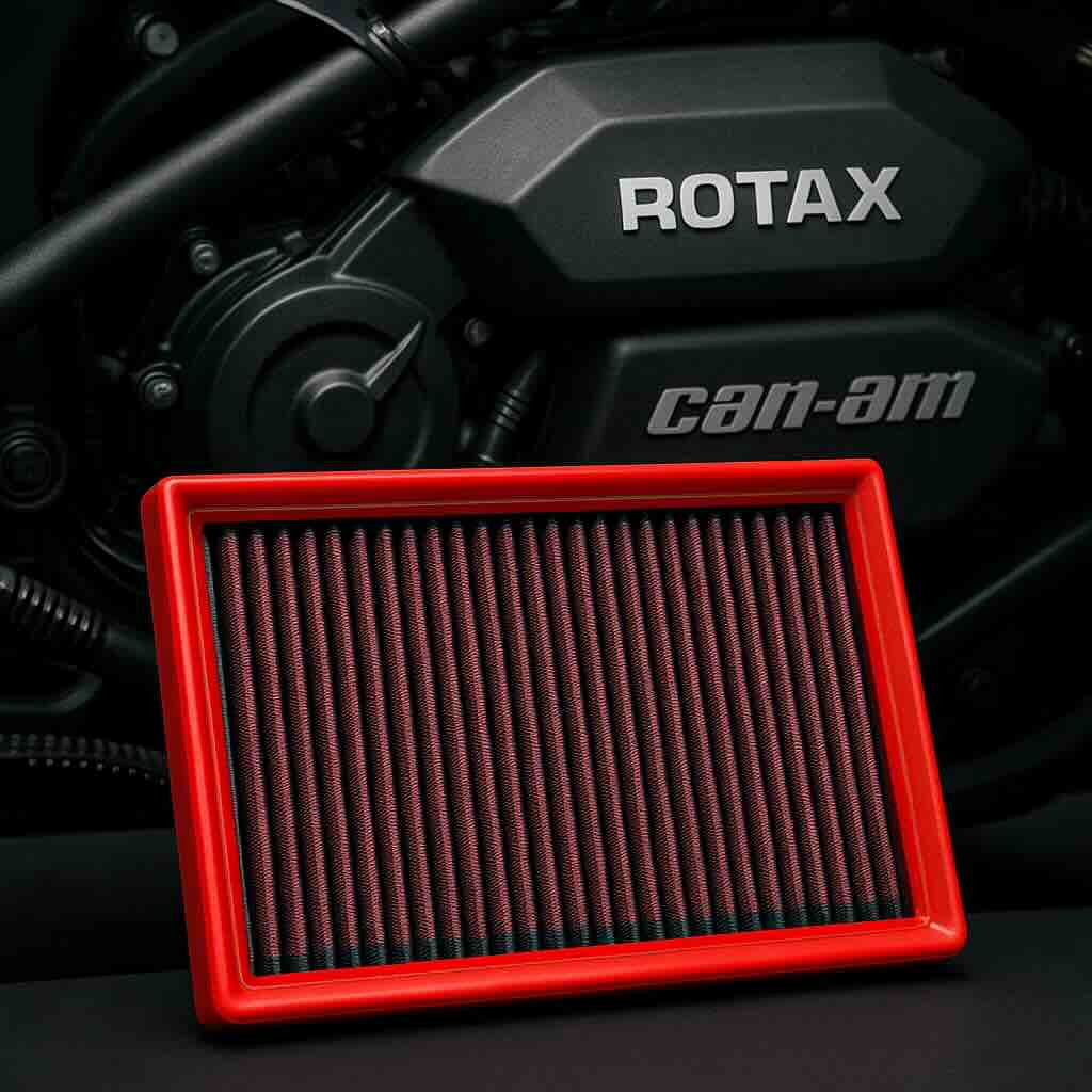 Red BMC performance air filter in front of a Can-Am Rotax engine – washable, high-flow filter designed for three-wheelers and power sports vehicles.