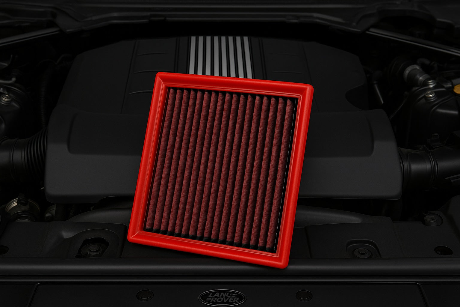 Red BMC performance air filter in front of a Land Rover Range Rover engine bay – premium washable filter designed for luxury SUVs and performance off-road vehicles.